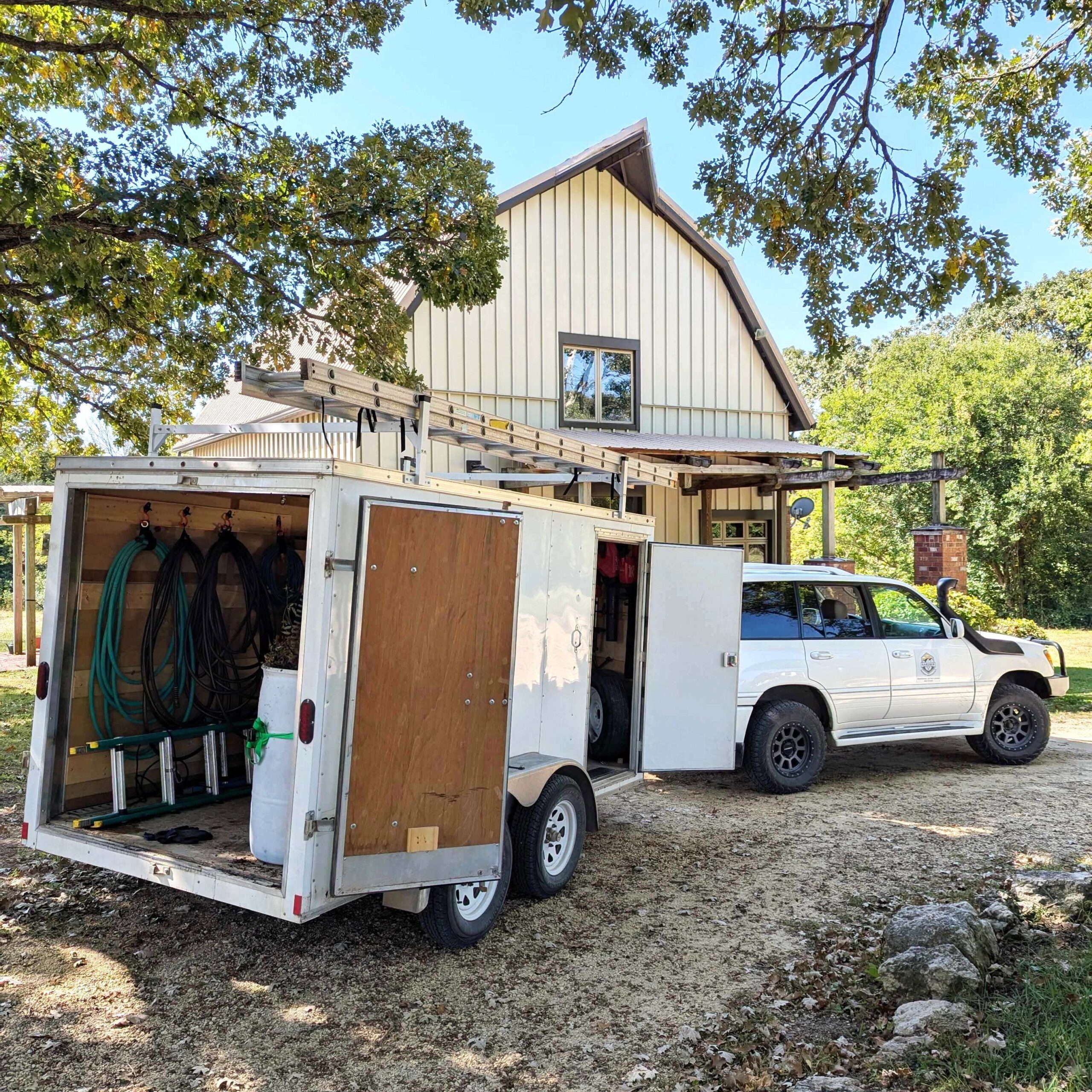 Gardner Property Maintenance truck and trailer equipped for professional gutter cleaning